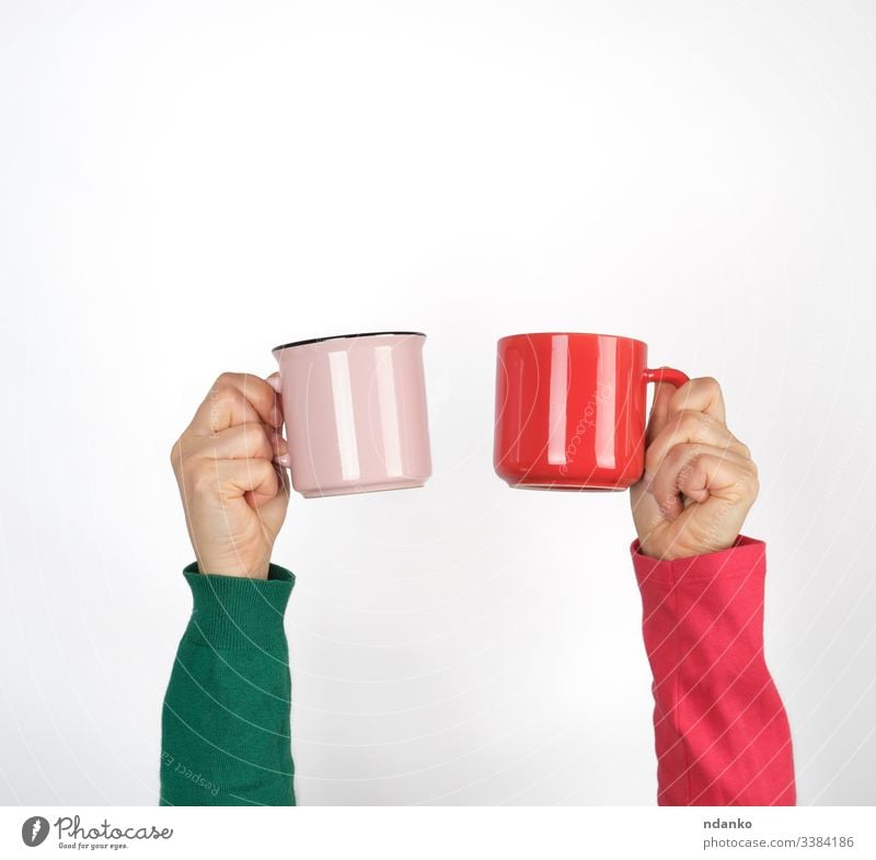 two hands holding ceramic mugs on a white background adult beverage breakfast caffeine cappuccino caucasian coffee concept cup design drink espresso female