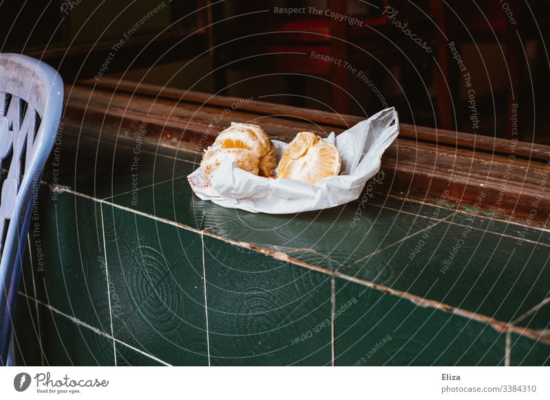 A peeled orange in a plastic bag on green tiles Orange Green fruit Plastic bag Colour photo Window Fruit Deserted Vegetarian diet Fresh Exterior shot Delicious