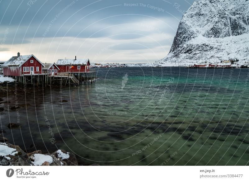 Fishing huts by the fjord in front of snowy mountains Vacation & Travel Trip Winter Snow Winter vacation Environment Landscape Sky Clouds Wind Ice Frost