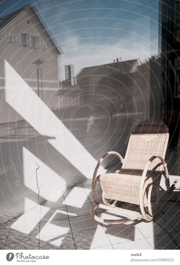 retirement home Shop window reflection Sunlight Shadow contast houses Sky Window roofs urban Rocking chair tranquillity Peaceful still life Reflection