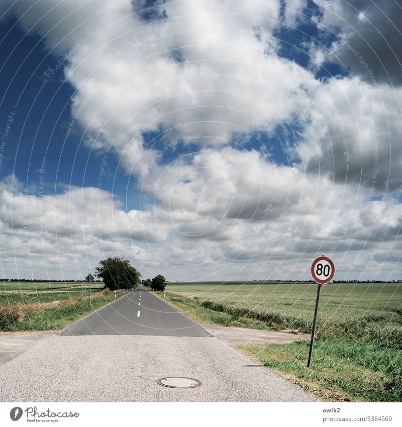 Watch out for speed cameras Street lowland Direct Right ahead Sky Clouds Horizon Landscape Deserted Exterior shot Far-off places Environment Copy Space bottom