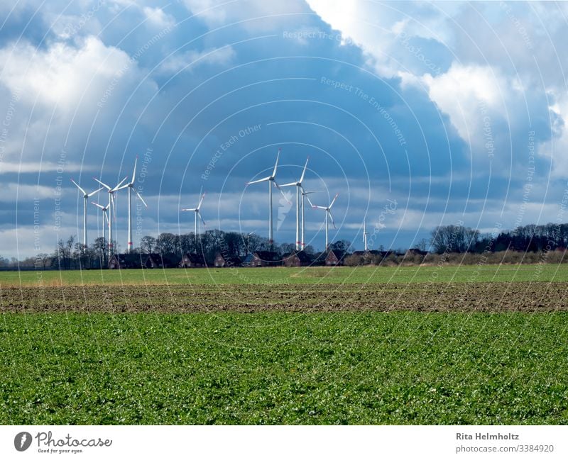 Wind turbines near houses and fields windmills wind farm repowering Colour photo Landscape Renewable energy Weather Clouds Raincloud Exterior shot Nature