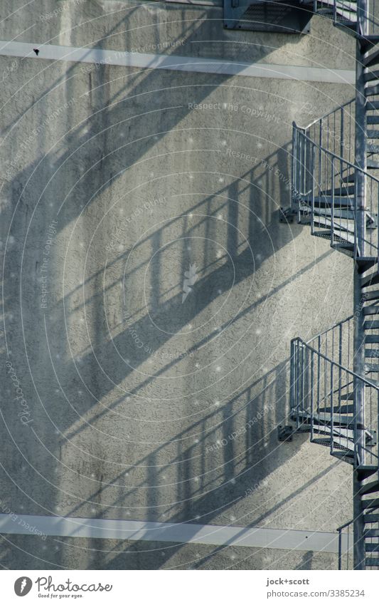 Stairs curved like the shadow on the fire wall Silhouette Structures and shapes Drop shadow Shadow play Symmetry Complex Gray Large rail Winding staircase