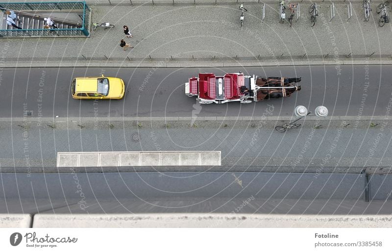 Berlin Friedrichstraße from above car carriage horses Lamp Pedestrian bicycles Bicycle rack staircases Subway access Red Yellow Gray Street Footpath urban