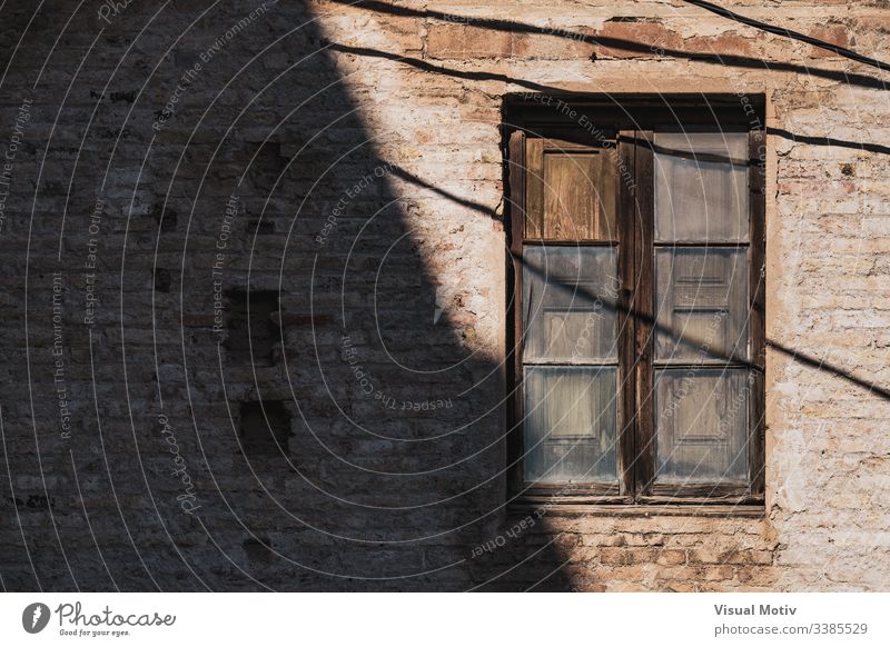 Wooden window of an old red brick building color traditional architecture architectural architectonic abstract outdoor outdoors exterior facade wooden