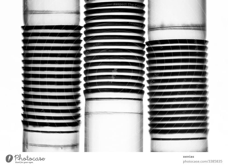 Three drinking straws with bends as macro shot in front of a bright background Drinking straws reeds Structures and shapes lines Abstract Design Plastic waste