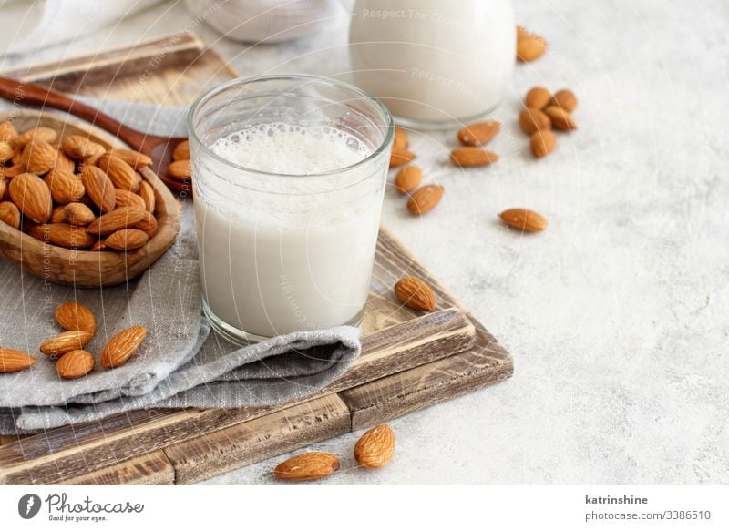 Vegan almond milk, non dairy alternative milk almonds beverage vegan glass jar breakfast diet drink pastel rustic tray napkin food fresh healthy homemade