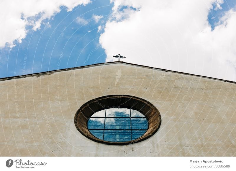 Low angle view of the church rooftop in Florence, Italy ancient architecture art blue building cathedral catholic christianity city clouds cross crucifix