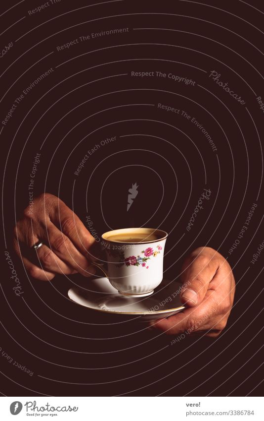 Man hands lift an old coffee cup Central perspective Deep depth of field Contrast Shadow Light Flash photo Artificial light Copy Space top Detail Studio shot