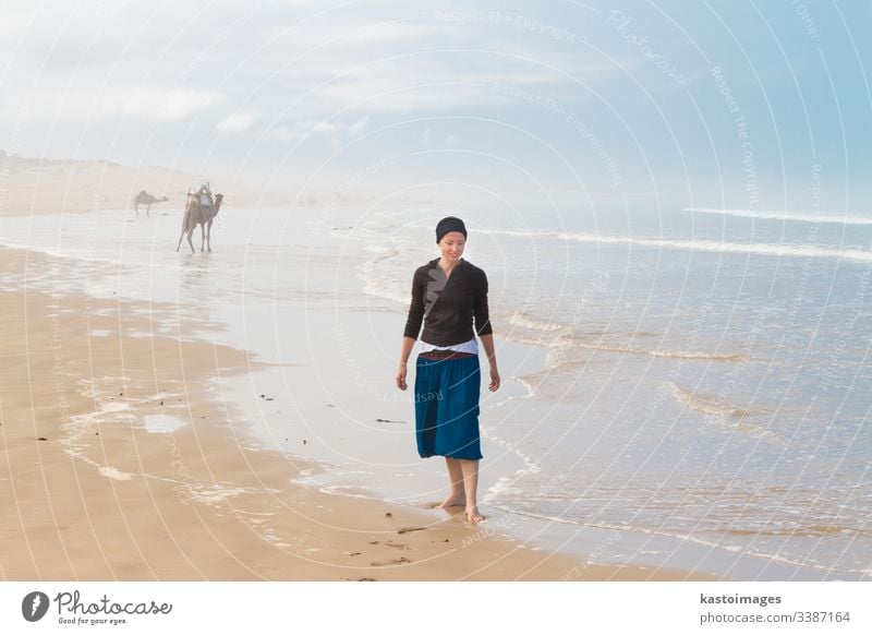 Female traveler enjoying on sandy beach near Essaouira, Morocco, Africa woman holiday people vacation summer outdoor Vacation & Travel beautiful relax tourist