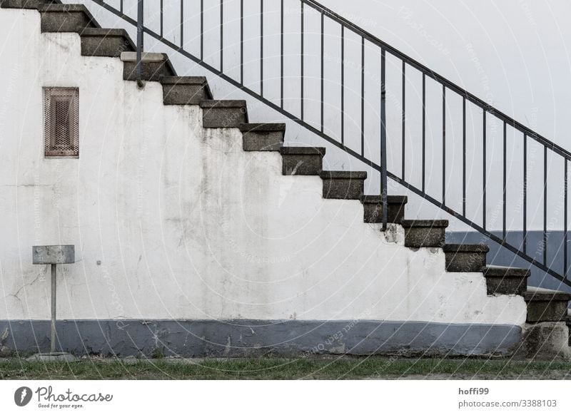 Stairs with banister and ashtray in front of dirty wall Diagonal Wall (building) Brick Minimalistic Pecking order Approach to the stairs Stone wall Arrangement