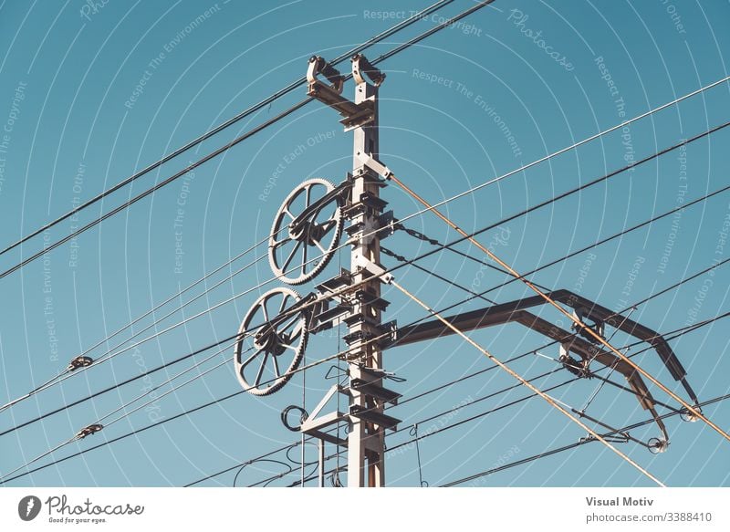 Railway catenary system and poles against clear blue sky detail transportation system railway system part railway catenary system outdoor outdoors exterior