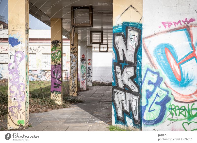 arcade with graffiti. Arcade portico Column Architecture Light Shadow Manmade structures Deserted Colour photo Day Exterior shot Building Contrast Old Facade