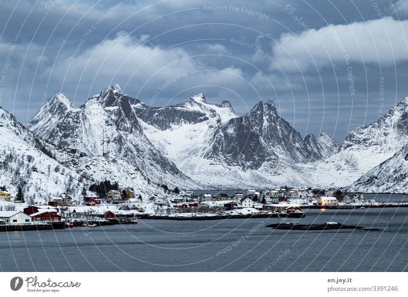 Fishing huts by the fjord in front of snowy mountains Vacation & Travel Trip Winter Snow Winter vacation Environment Landscape Sky Clouds Ice Frost