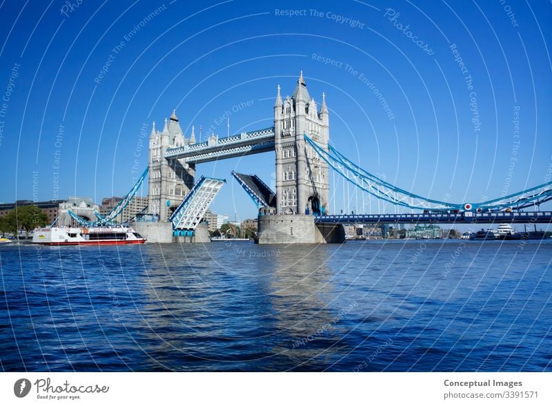 Tower Bridge with the Drawbridge raised, London, England. architecture attraction britain british british culture capital capital cities city cityscape dusk