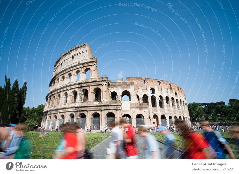 Tourists walking past the Colosseum during the day. Rome. Italy. amphitheater ancient archeology architecture arena cityscape coliseum colosseum culture