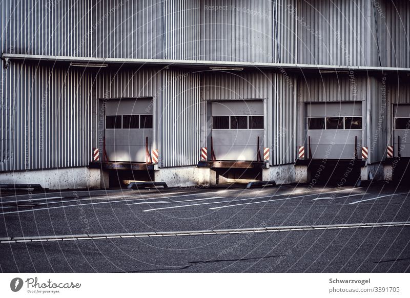 Loading ramp for trucks Goal Facade Invite logistics Exterior shot Logistics Trade Deserted Building Factory Warehouse Industrial plant Colour photo Day