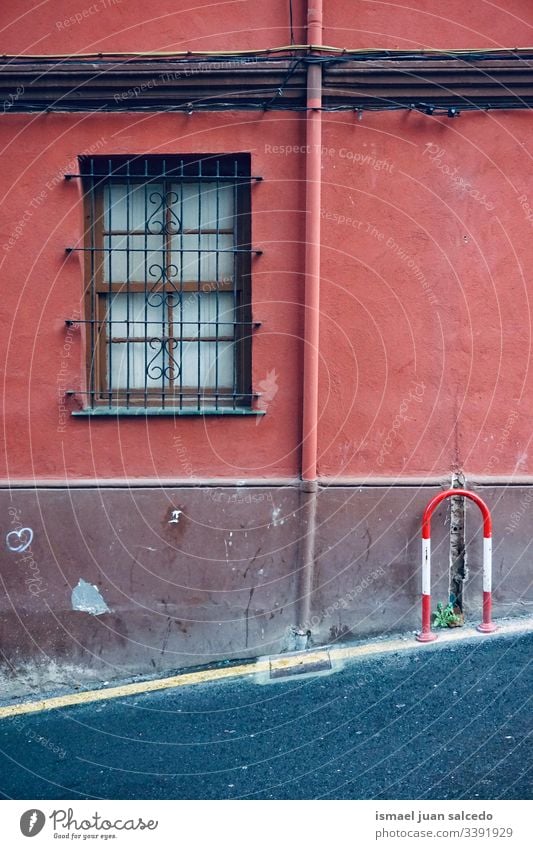 window on the old red facade of the house, architecture in Bilbao city Spain building exterior home street outdoors color colorful structure construction wall