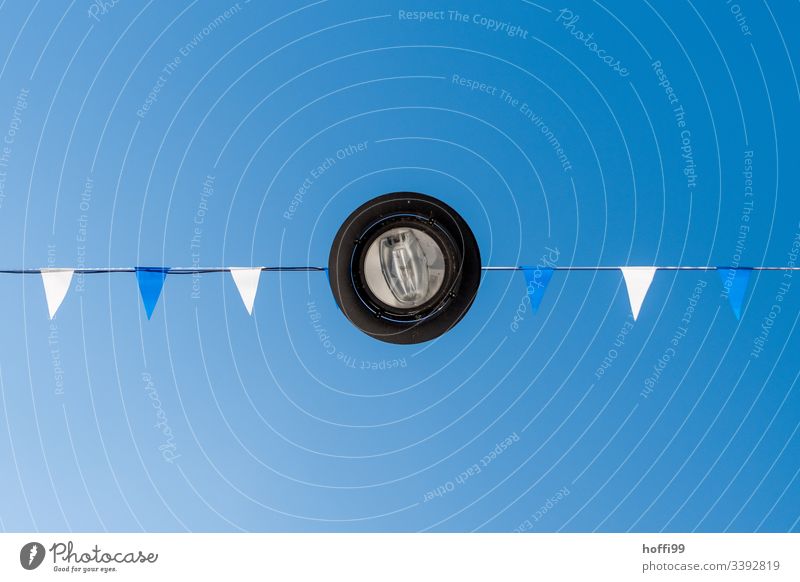 Lamp from below with white and blue flags against blue sky Lantern light Flag Street lighting Minimalistic Blue sky Blue background Summer Exterior shot