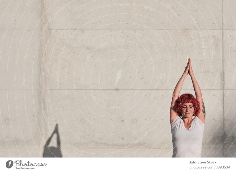 Woman in tree pose practicing yoga on street athlete balance namaste woman meditate practice training exercise stretch concrete calm vrikshasana fit urban