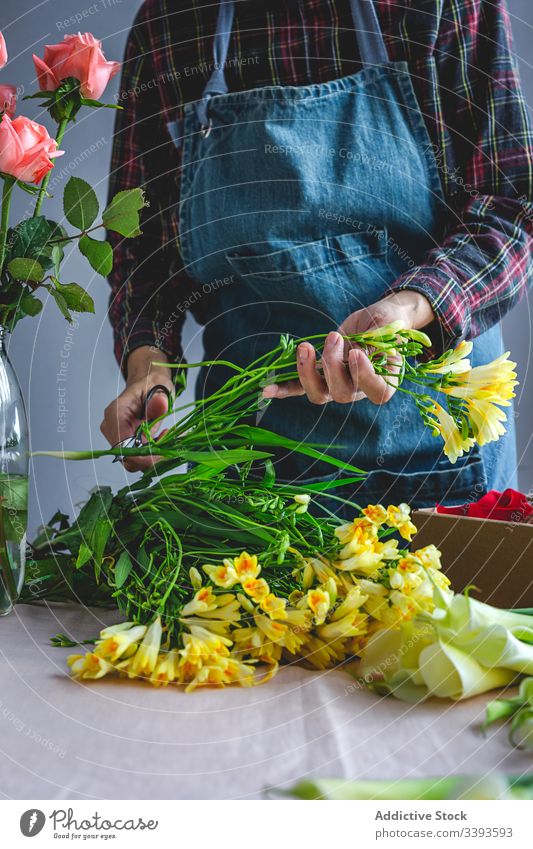 Unrecognizable female professional florist making bouquets. Blooming background owner composition beautiful creative floral craft yellow flowers job workshop