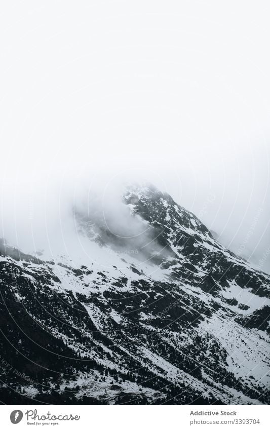 Winter mountain landscape with snow winter severe rock peak cold white fog snowstorm nature sky high season scenic travel tourism world wild wilderness blizzard