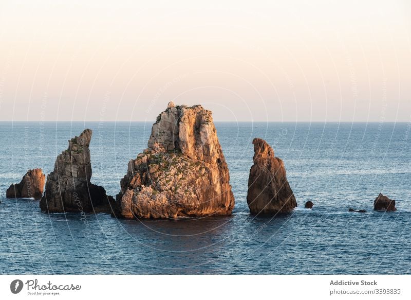 Peaceful landscape of rocky cove in sunset scenery peaceful sea skyline twilight coastline nature water destination tourism seascape cliff stone holiday summer