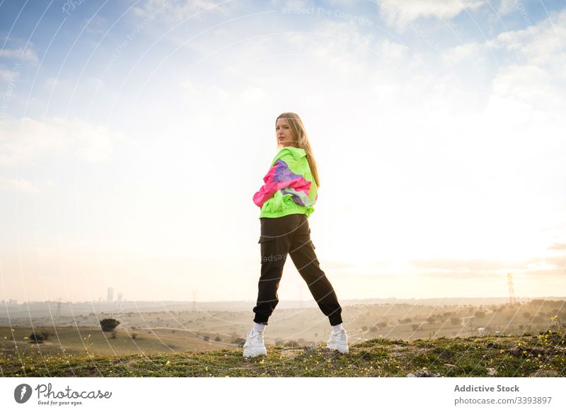 Female hipster in colorful sportswear in countryside woman nature modern blond casual summer individuality style fit cool trendy vivid young athlete female