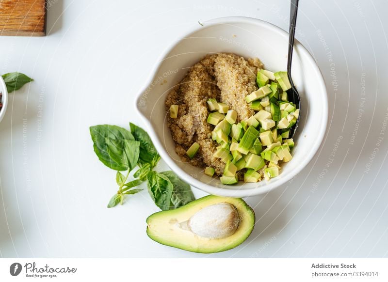 Bowl with quinoa and avocado recipe bowl ingredient food cooking vegetable healthy green kitchen meal dinner lunch preparation fresh chopped leaves basil