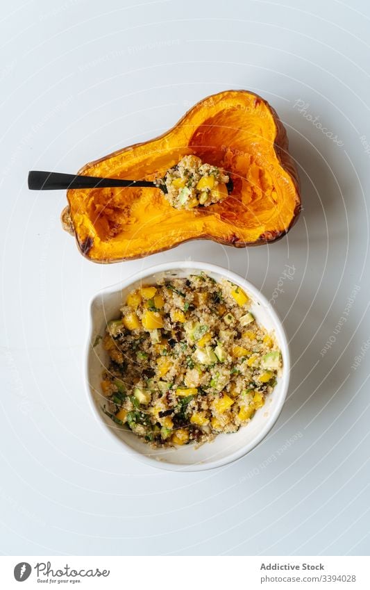 Half of pumpkin and bowl with filling stuffed vegetarian food cooking baked half squash vegan ingredient recipe butternut vegetable quinoa roasted orange