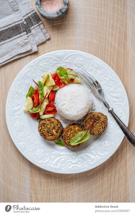 Vegan dish with patties on white plate food vegetarian cutlet vegan healthy natural served cooking vegetable rice salad appetizing recipe ingredient kitchen