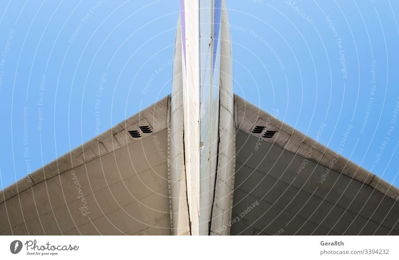 fragment of airplane wings on a background of blue sky air transport aviation color detailed engineering flight fly iron isolated mechanism metal old part speed