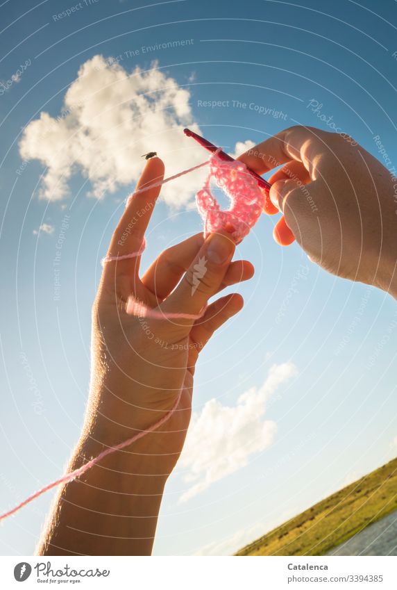 Crochet hands with fly extend to the sky Ball of wool Leisure and hobbies Handcrafts Wool Soft Relaxation Warmth crochet hook Detail Contentment pink light blue