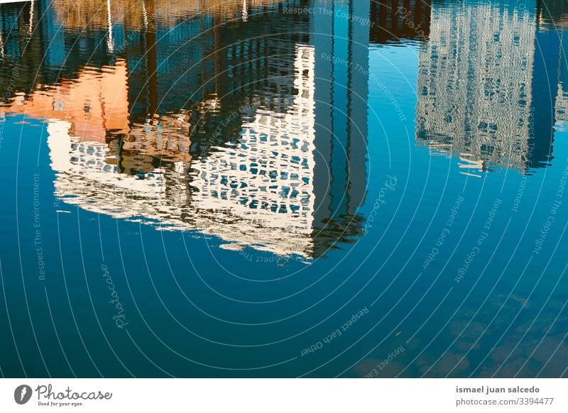 building reflected on the water in the river in Bilbao city Spain reflection light bright liquid sunlight blue abstract texture background pattern ripple wave