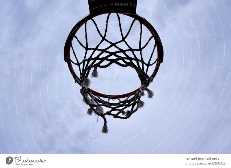 basketball hoop silhouette, street basket in Bilbao city Spain sky blue circle chain metallic net sport sports equipment play playing playful old park