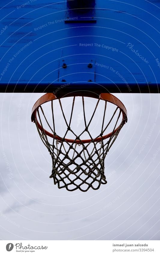 basketball hoop, street basket in Bilbao city Spain sky blue silhouette circle chain metallic net sport sports equipment play playing playful old park