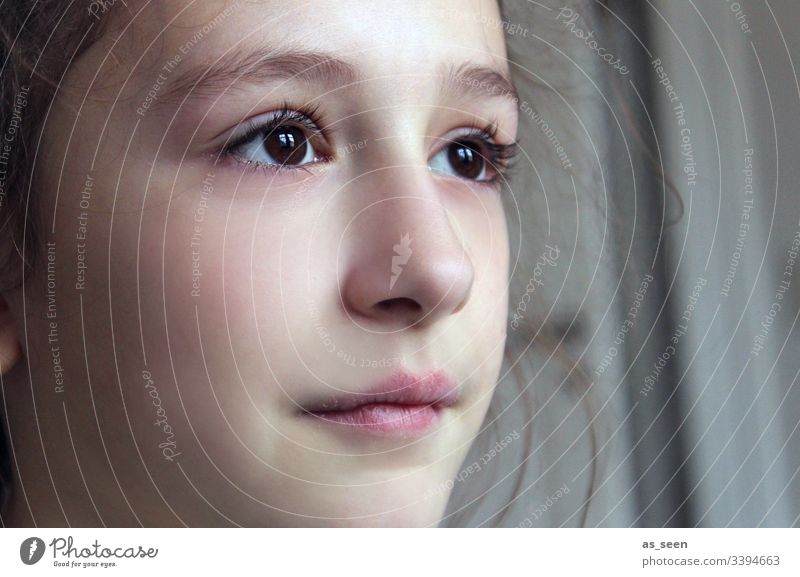 Girl looks out the window Looking brown eyes Face Window see Brunette Portrait photograph Colour photo Close-up Beautiful Shallow depth of field