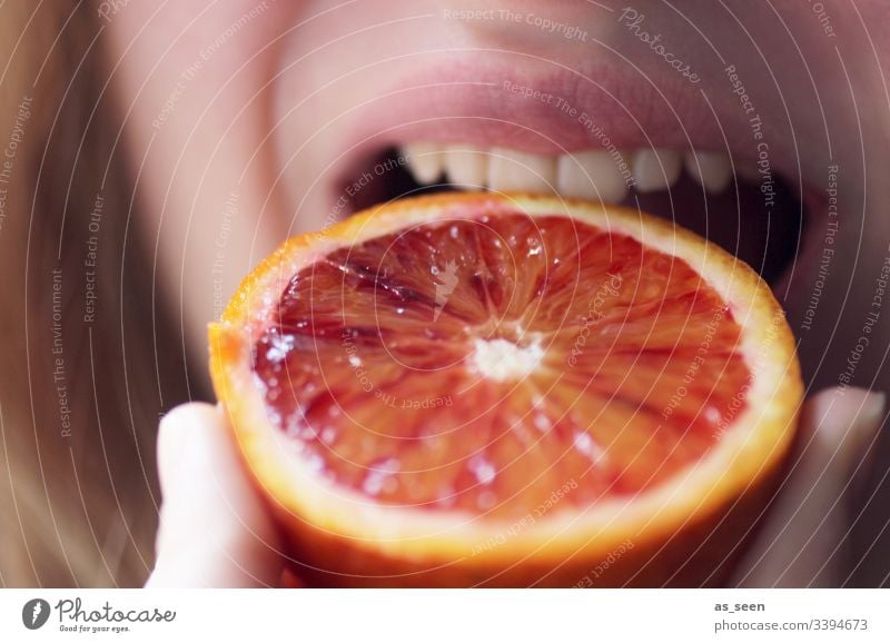 Woman bites into juicy orange Orange Fruit Macro (Extreme close-up) Nutrition Food Healthy Vegetarian diet Colour photo Organic produce Interior shot Diet