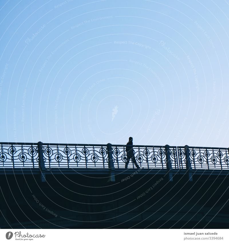 tourist walking on the street in Bilbao city Spain, Bilbao travel destination person people human pedestrian shadow silhouette bridge outdoors abstract minimal