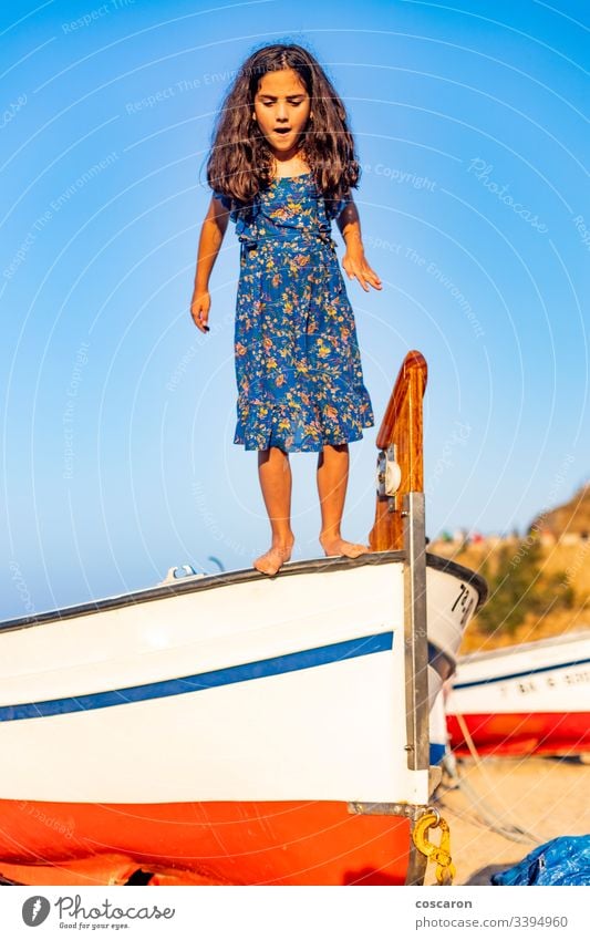 Little child jumping from a boat with a blue sky background active air beach beautiful boy carefree cheerful childhood coast coastline energy enjoy fly freedom