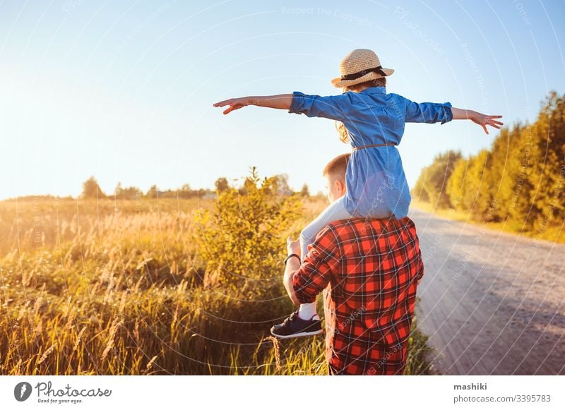 happy father and daughter walking on summer meadow, having fun and playing. Father's day, fatherhood concept. Rural living. child family girl love lifestyle