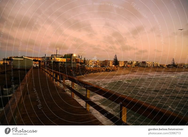 Harbour town in Namibia with landing stage in the foreground daylight Summer Panorama photo View from Landungsbrücke to the city few colours houses Factory