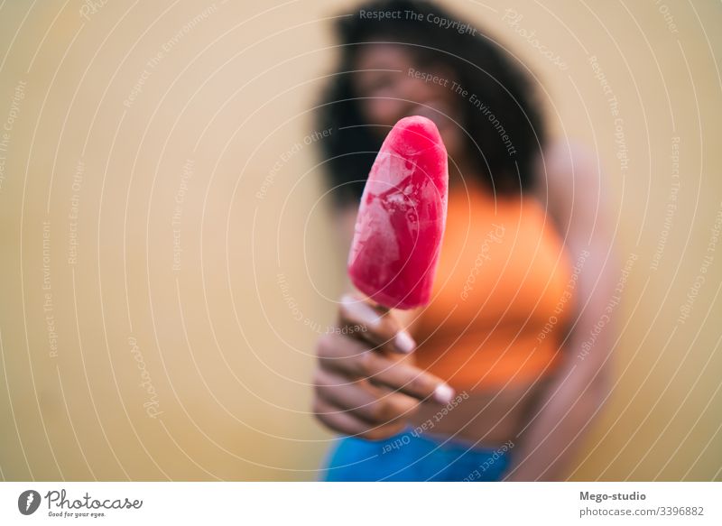 Afro woman enjoying summertime and eating an ice-cream afro holding happiness portrait positive smiling expression looking taste stylish summer lady fresh one