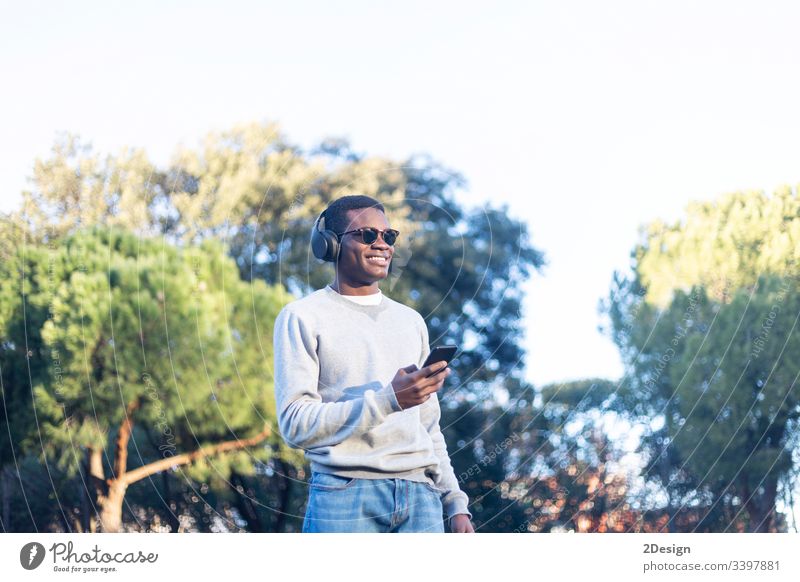 Afro young man using mobile phone. style technology 1 lifestyle attitude male black street casual attire mulatto leisure trendy happy photogenic calling african