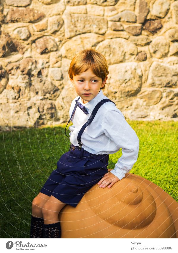 Little elegant ring bearer at garden wedding boy junior groom child bouquet flowers summer portrait floral fashion rose kid nature face sun happy beautiful