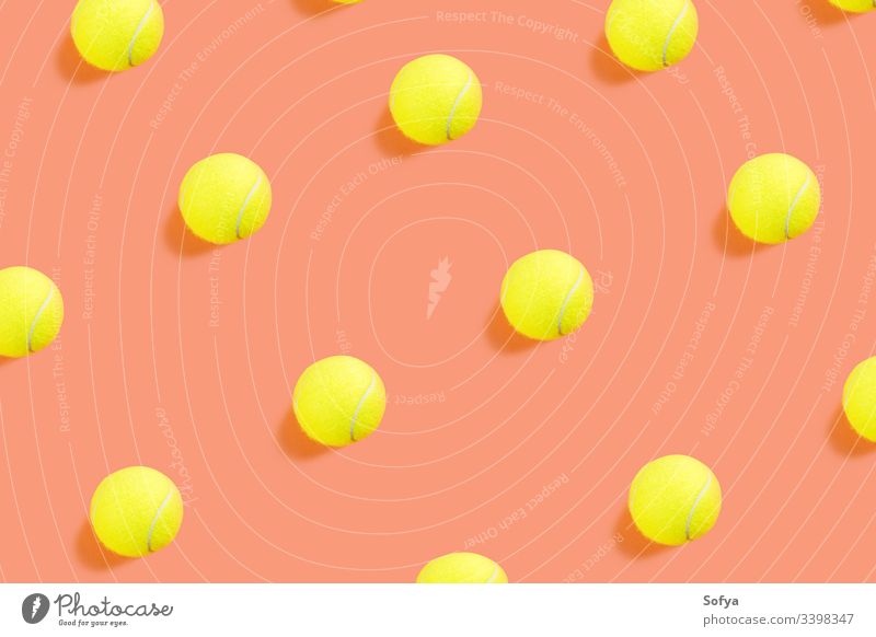 Yellow tennis ball pattern on orange coral background competition color concept top view equipment flat lay racket sport yellow trendy play teaching game match