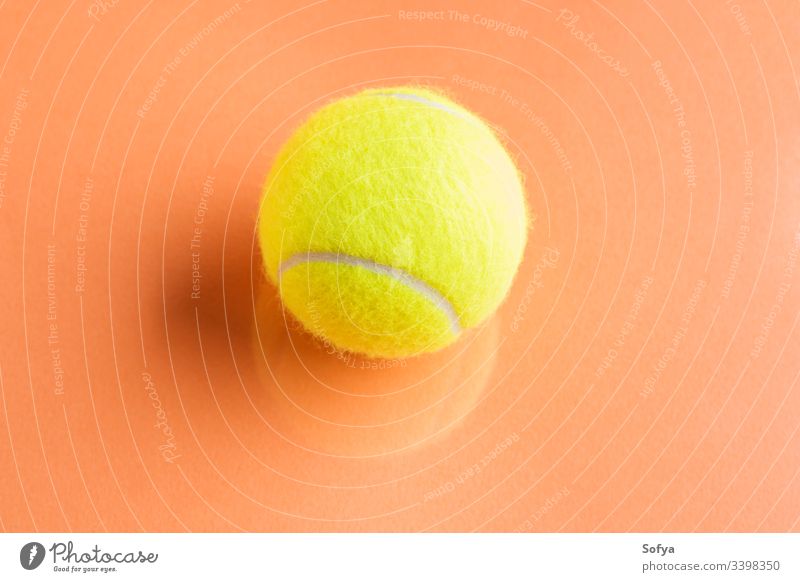 Tennis ball on orange abstract background with reflection. tennis competition concept motion equipment racket sport yellow trendy play teaching game match point