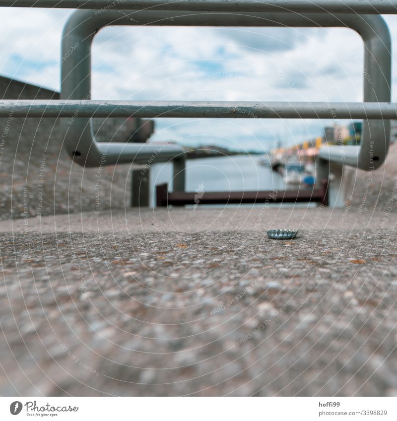 Crown caps on quay wall with view into the harbour basin Crown cork Trash waste Jetty Footbridge Water Watercraft Lake Wood Harbour Nature Moody Reflection