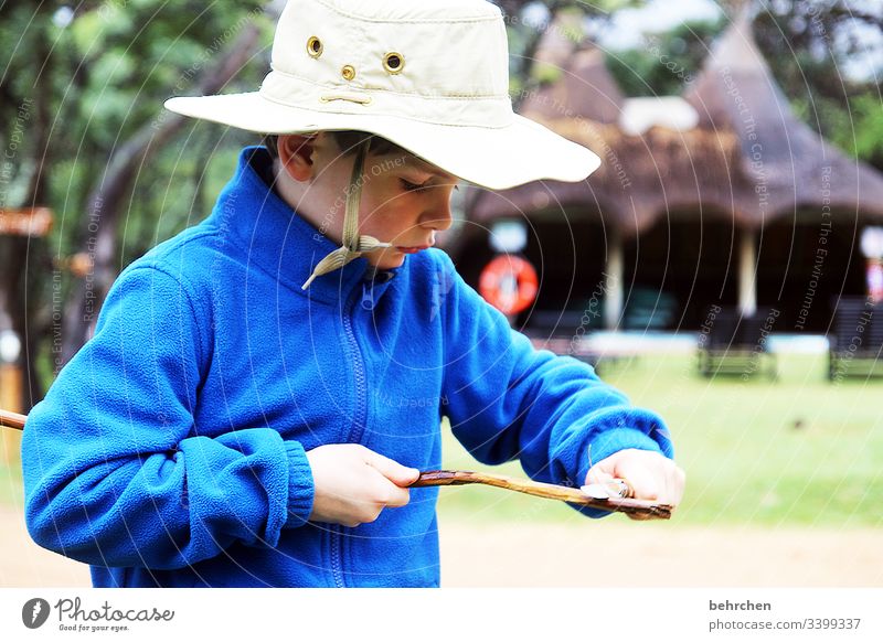 back to the roots | hunter and gatherer Cool Cool (slang) Cowboy hat Hat Brash observantly Boy (child) Child Family & Relations Infancy Carve Knives Stick