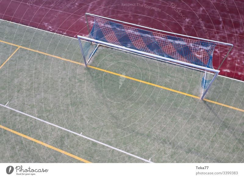 a soccer field goal from above soccer goal lines sport sport place green small soccer field grass sun shadow sports